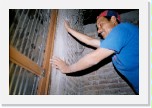 Beto helping to install the doorframe * On the other side of the door...
Beto is holding a plank so that the cement that Juan and Cheche are throwing stays where it's supposed to! :) Don't you love the expression on his face! That's the I love God and I'm glad to be serving Him, but I sure am tired after painting all day in the hot sun at my regular job and fixing up this room until 11:00pm at night smile! Can you believe he's still smiling at all? What an amazing servant of God! * 672 x 448 * (125KB)