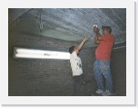 Fili and Juan installing a light * Fili and Juan working on the electrical connections for the lights. Don't try this at home! Those are live wires!! * 599 x 451 * (105KB)